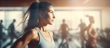 Closeup face of determined woman doing aerobic exercises at gym standing with arms outstretched Determined young woman in sportswear stretching arms in gym Beautiful girl in yoga pose with clas