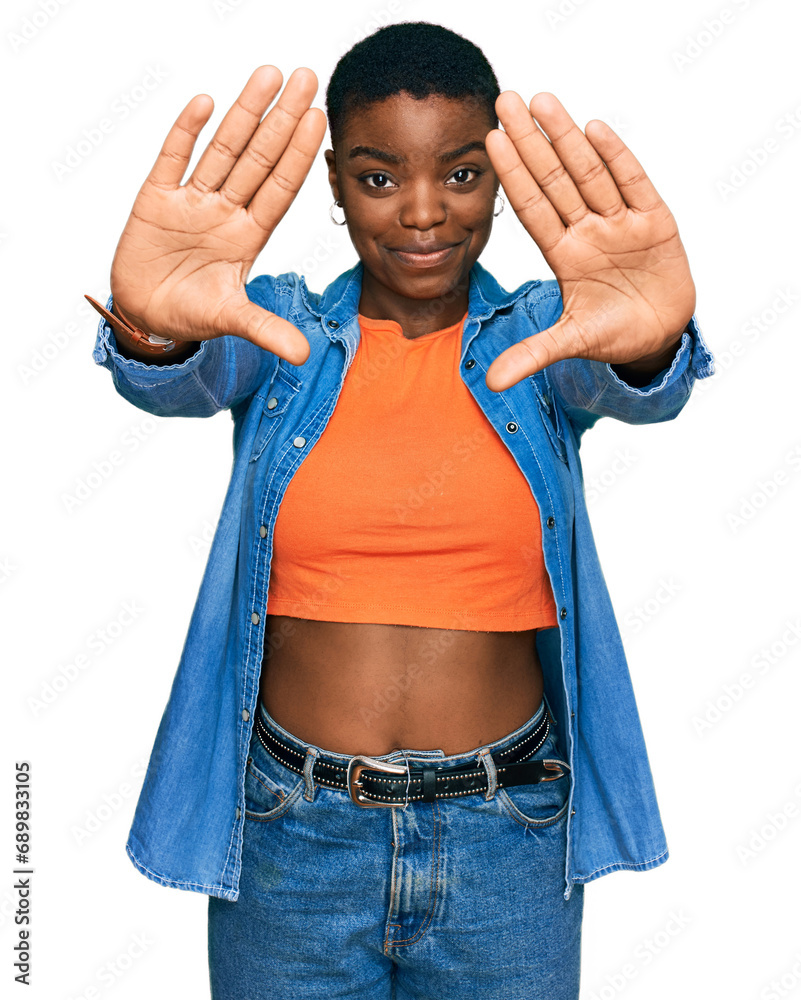 Young african american woman wearing casual clothes doing frame using hands palms and fingers, camera perspective
