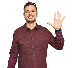 Poster - Young hispanic man wearing casual clothes showing and pointing up with fingers number five while smiling confident and happy.