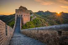 View Of The Great Wall Of China At Sunset Across The Mountain In China.