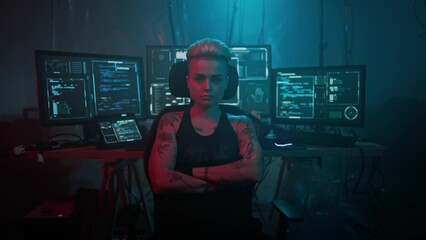 Woman with crossed arms against screens displaying code