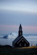 View Of Church / Chapel In Front Of Icebergs At Night In Ilulissat, Greenland.
