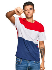 Poster - Young handsome african american man wearing casual clothes looking unhappy and angry showing rejection and negative with thumbs down gesture. bad expression.