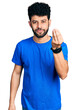 © Krakenimages.com - Young arab man with beard wearing casual blue t shirt doing italian gesture with hand and fingers confident expression