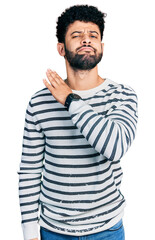 Canvas Print - Young arab man with beard wearing casual striped sweater cutting throat with hand as knife, threaten aggression with furious violence