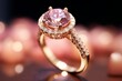Macro shot golden ring with amazing pink diamond represented in a jewelry shop with lights on background.