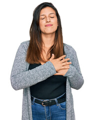 Canvas Print - Beautiful hispanic woman wearing casual clothes smiling with hands on chest with closed eyes and grateful gesture on face. health concept.