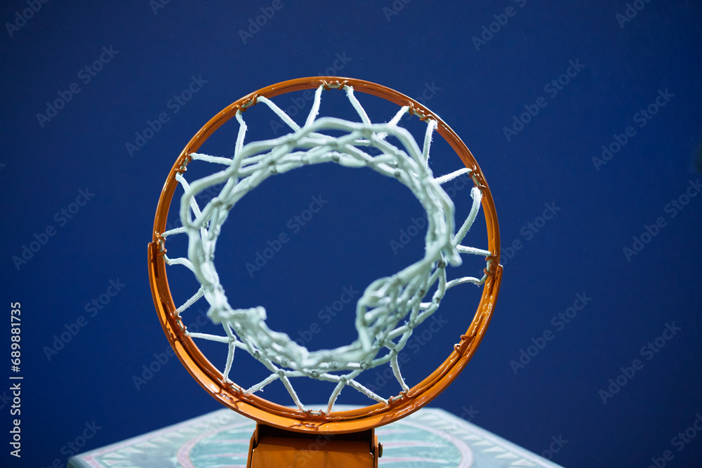 Basketball hoop with a net in a sunset sky. Stock Photo | Adobe Stock