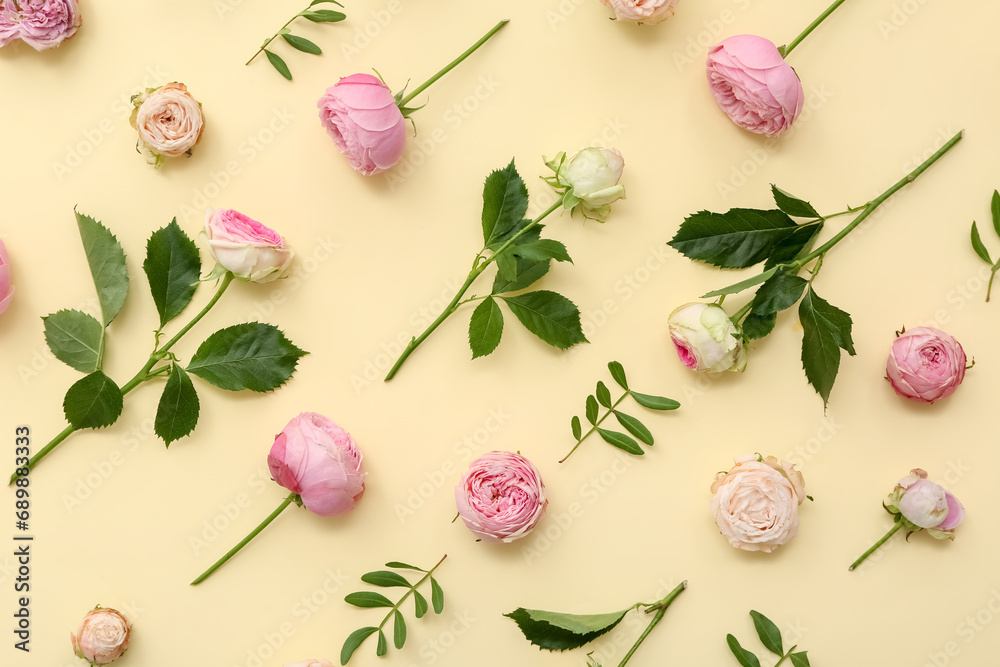 Beautiful pink roses and leaves on yellow background