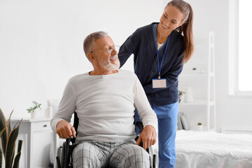 Poster - Senior man in wheelchair with caregiver at home