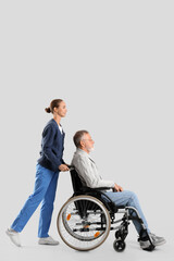 Sticker - Senior man in wheelchair with nurse on light background