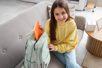 Poster - Little schoolgirl with copybook in backpack at home