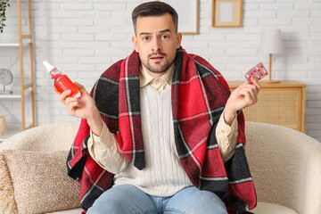 Poster - Sick young man with pills and spray for sore throat at home