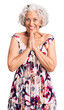 © Krakenimages.com - Senior grey-haired woman wearing casual clothes praying with hands together asking for forgiveness smiling confident.