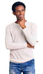 Wall Mural - African handsome man wearing casual winter sweater with hand on chin thinking about question, pensive expression. smiling with thoughtful face. doubt concept.