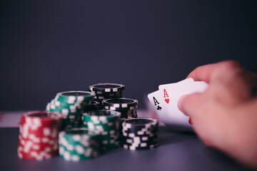 Dealer or croupier shuffles poker cards in a casino on the background of a table, chips. Concept of poker game, game business. Playing for money, a big win, a jackpot, gambling, a desire to get rich.	