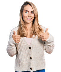 Wall Mural - Young blonde woman wearing casual clothes success sign doing positive gesture with hand, thumbs up smiling and happy. cheerful expression and winner gesture.