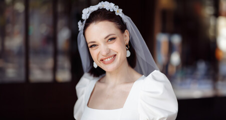 beautiful young woman bride happy on her wedding day in a white dress and veil.