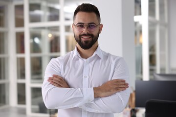 Canvas Print - Portrait of smiling man with crossed arms in office. Lawyer, businessman, accountant or manager