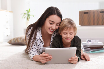 Poster - Mother and son reading E-book together at home