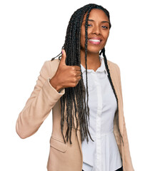 Wall Mural - African american woman wearing business jacket doing happy thumbs up gesture with hand. approving expression looking at the camera showing success.