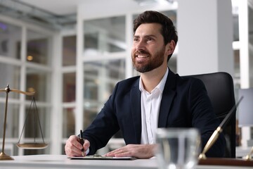 Wall Mural - Portrait of smiling lawyer at table in office