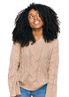 © Krakenimages.com - Young african american girl wearing casual clothes looking away to side with smile on face, natural expression. laughing confident.