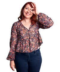 Wall Mural - Young beautiful redhead woman wearing casual t-shirt doing ok gesture with hand smiling, eye looking through fingers with happy face.