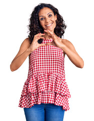 Canvas Print - Middle age beautiful woman wearing casual sleeveless t shirt smiling in love showing heart symbol and shape with hands. romantic concept.