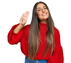 Wall Mural - Beautiful hispanic woman wearing casual clothes waiving saying hello happy and smiling, friendly welcome gesture