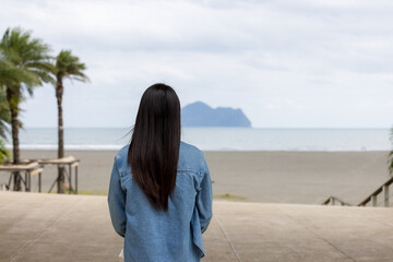 Wall Mural - Tourist woman look at the Guishan island In Yilan of Taiwan