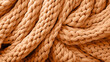 Peach fuzz trendy color of 2024 year. knitted sweater texture closeup.