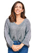 © Krakenimages.com - Young brunette woman wearing casual winter sweater looking positive and happy standing and smiling with a confident smile showing teeth