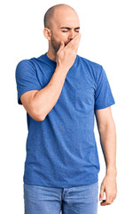 Wall Mural - Young handsome man wearing casual t shirt bored yawning tired covering mouth with hand. restless and sleepiness.