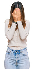 Wall Mural - Young woman wearing casual clothes with sad expression covering face with hands while crying. depression concept.