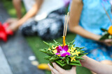 Fototapeta Lawenda - 
Thai people hold a krathong that is a beautiful small basket made from a piece of a banana tree trunk and decorated with banana leaves, flowers, incense sticks and a candle. 
