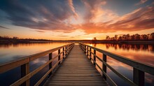A Serene Sunset Over A Calm Lake With A Small Wooden Dock