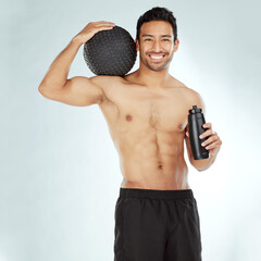 Canvas Print - Fitness, water and portrait of happy man with medicine ball in studio for wellness, training and hydration on white background. Face, smile and male athlete with workout, results or body progress