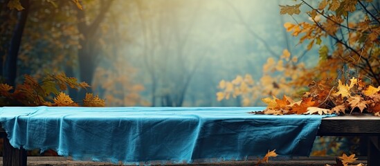 Poster - Autumn forest landscape with blue wooden table cover, ready for your decorations.