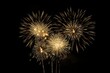 © Wuttichai - Golden explosions of color. Spectacular fireworks display lighting up night sky in celebration of joyous festival or holiday event. Vivid and bright fireworks illuminate dark background