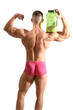 © theartofphoto - Young handsome male bodybuilder holding protein container, isolated on white, seen from behind