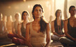 some women pose in meditation in a sitting pose in a yoga studio