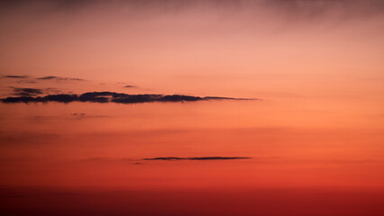 Wall Mural - The sky blazed with vibrant colors during the sunset, showcasing the beauty of nature. The clean sky was painted with a beautiful gradient of warm and cool tones during sunset.
