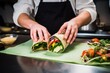 a chef wrapping up a turkey and avocado wrap