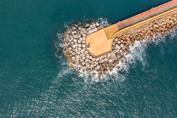 Canvas Print - Pier with concrete blocks as breakwater