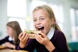 girl gleefully bites into a vegan sandwich during lunchtime in school