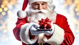 Fototapeta  - Święty Mikołaj wręczający smartfon z czerwoną kokardą