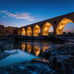 iran ancient bridge over river at blue hour night.