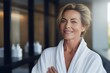 Headshot of happy smiling beautiful middle aged woman wearing bathrobe at spa salon hotel looking at camera. Wellness spa procedures advertising. Skincare concept.