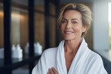 Headshot of happy smiling beautiful middle aged woman wearing bathrobe at spa salon hotel looking at camera. Wellness spa procedures advertising. Skincare concept.